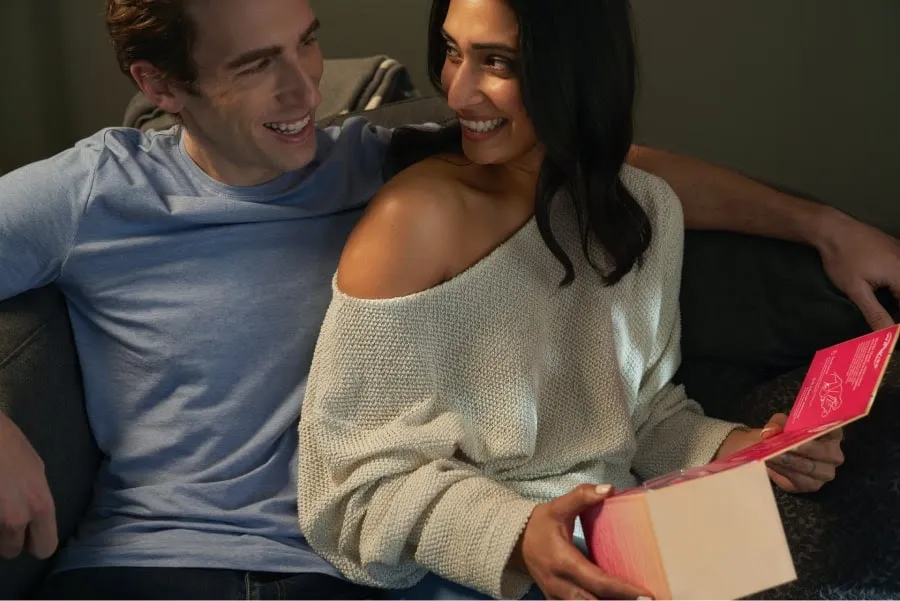 A woman happily receiving a gift rom a man